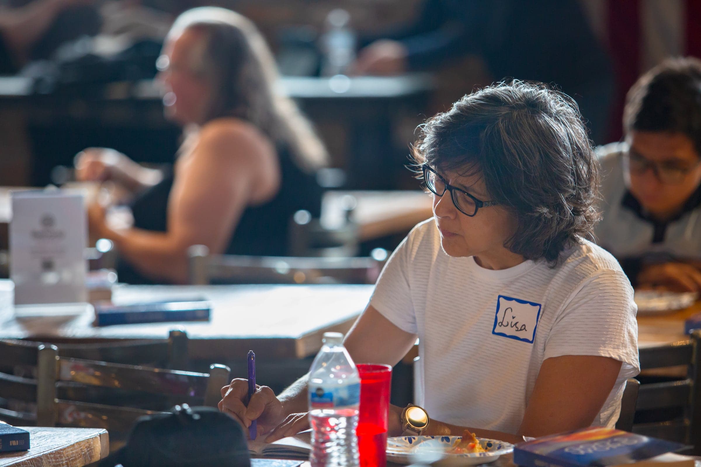 A member taking notes during a Bethany gathering